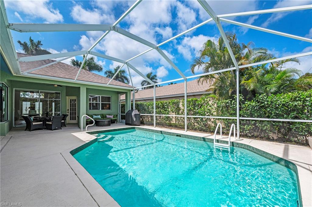 2039 Terrazzo Lane Naples, FL 34104 - Photo 21 of 29 a view of a backyard with sitting area and porch