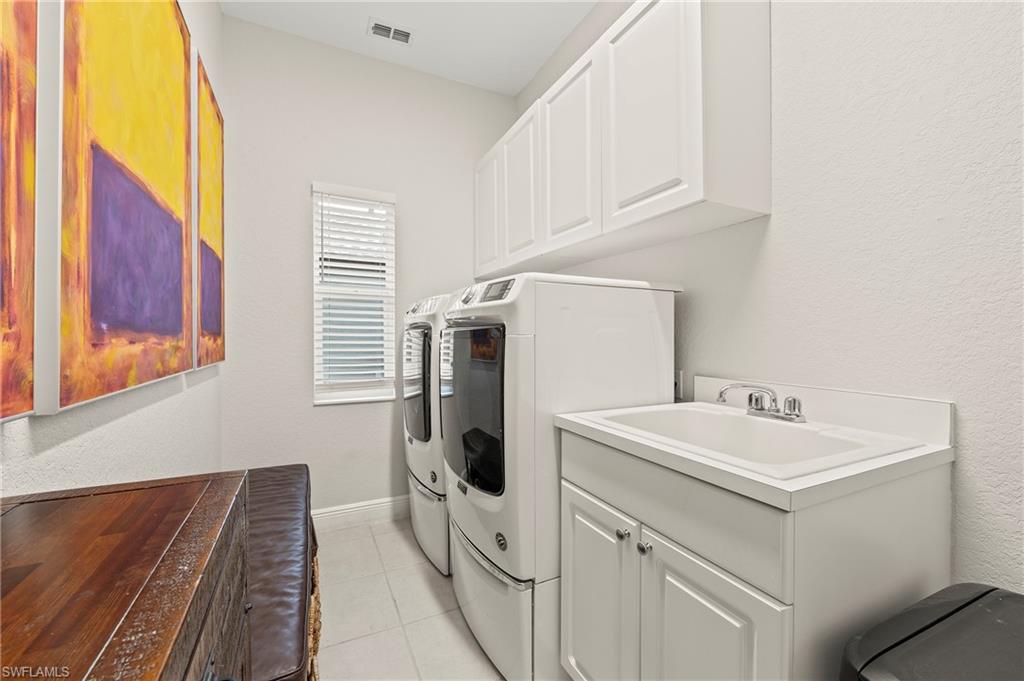 2039 Terrazzo Lane Naples, FL 34104 - Photo 23 of 29 a utility room with dryer and washer
