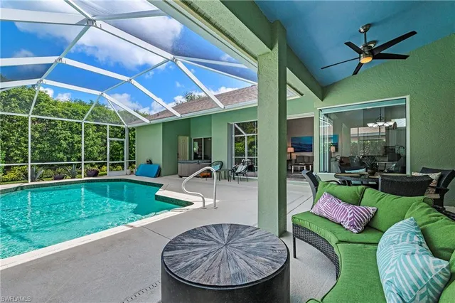 a view of a patio with couches chairs and a umbrella
