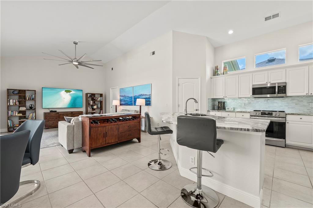 2039 Terrazzo Lane Naples, FL 34104 - Photo 6 of 29 a living room with furniture and a view of kitchen