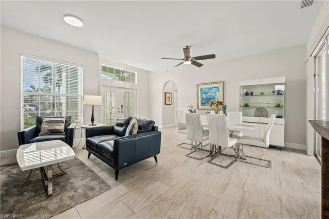 a living room with furniture a window and a table