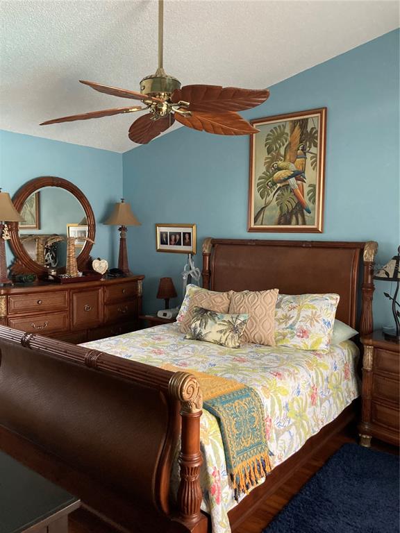 8101 Roxboro Drive Hudson, FL 34667 - Photo 12 of 47 a bedroom with a bed and a painting on the wall