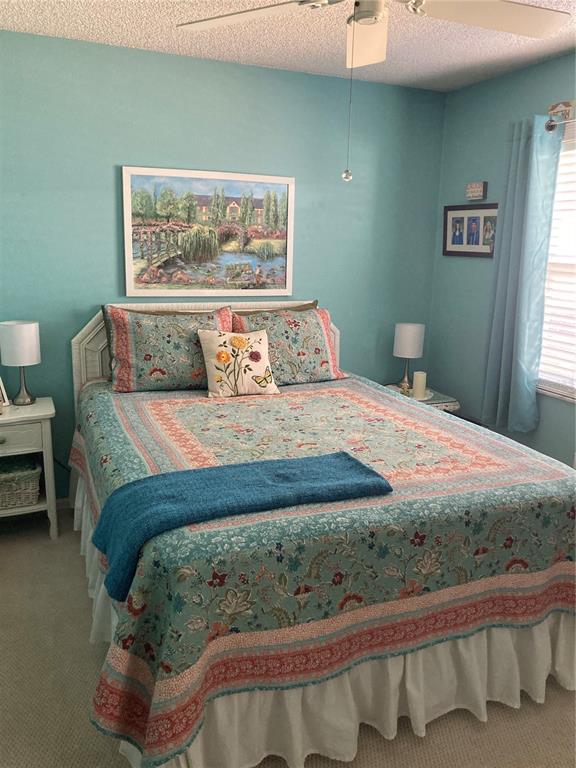 8101 Roxboro Drive Hudson, FL 34667 - Photo 19 of 47 a bedroom with a bed and a painting on the wall