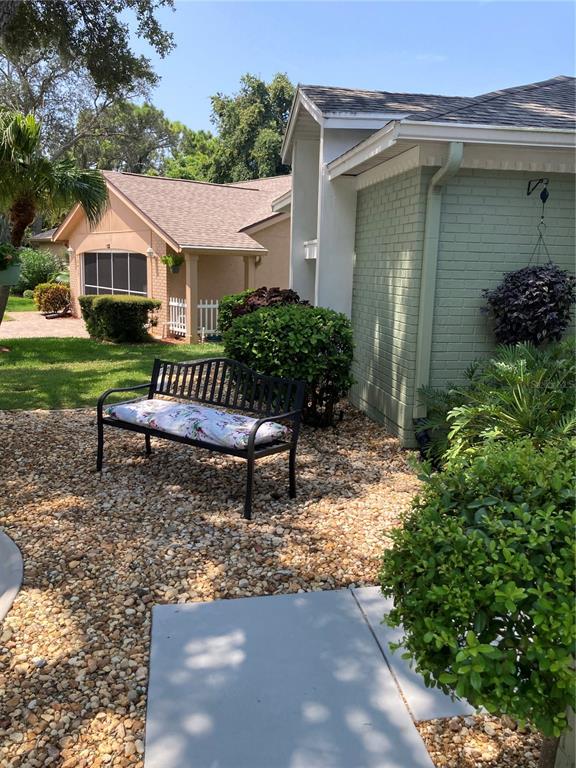 8101 Roxboro Drive Hudson, FL 34667 - Photo 2 of 47 a front view of a house with garden
