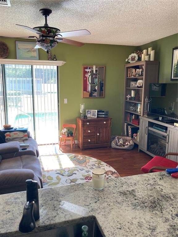 8101 Roxboro Drive Hudson, FL 34667 - Photo 22 of 47 a living room with furniture and a flat screen tv