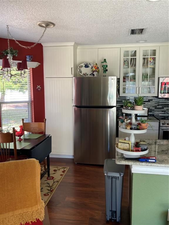 8101 Roxboro Drive Hudson, FL 34667 - Photo 27 of 47 a kitchen with stainless steel appliances a refrigerator and a stove top oven