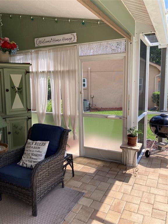 8101 Roxboro Drive Hudson, FL 34667 - Photo 30 of 47 a building outdoor space with patio furniture and potted plants