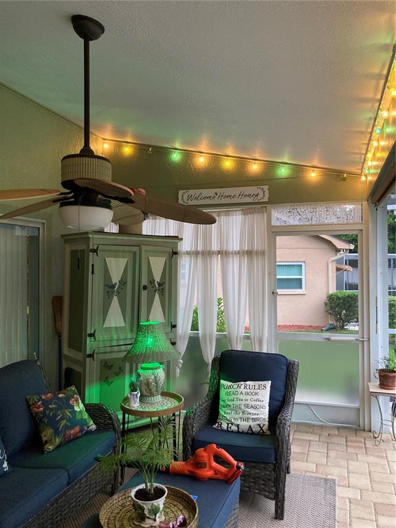 8101 Roxboro Drive Hudson, FL 34667 - Photo 45 of 47 a living room with furniture and a floor to ceiling window