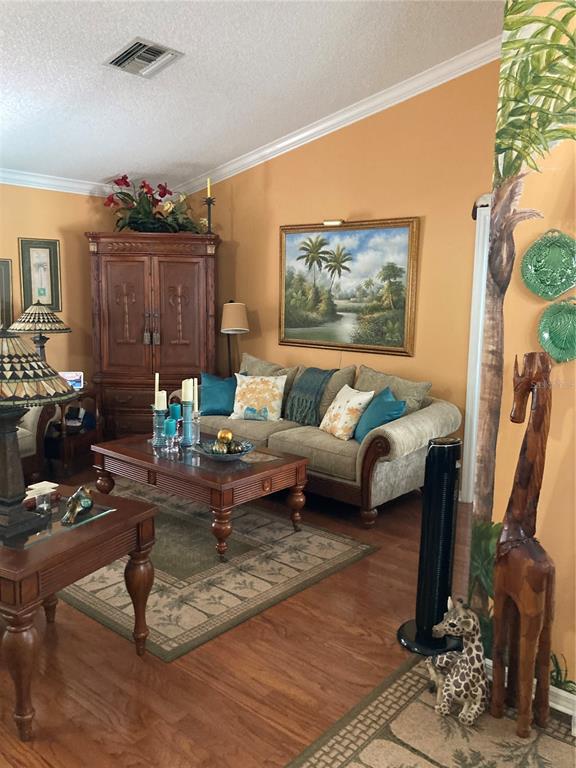 8101 Roxboro Drive Hudson, FL 34667 - Photo 7 of 47 a living room with furniture and a wooden floor