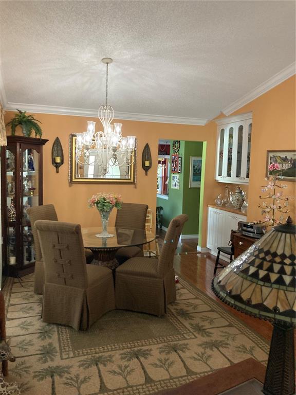 8101 Roxboro Drive Hudson, FL 34667 - Photo 8 of 47 a living room with furniture and a chandelier