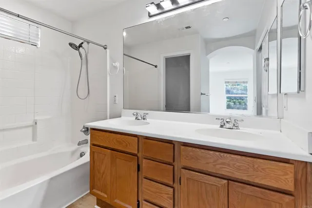 a bathroom with a granite countertop sink a toilet and shower