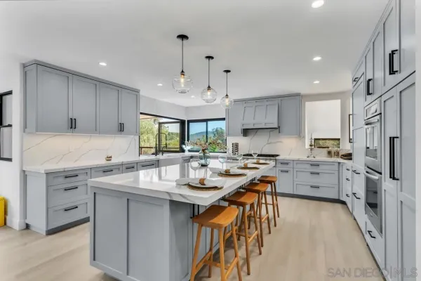 a kitchen with white cabinets sink and stainless steel appliances