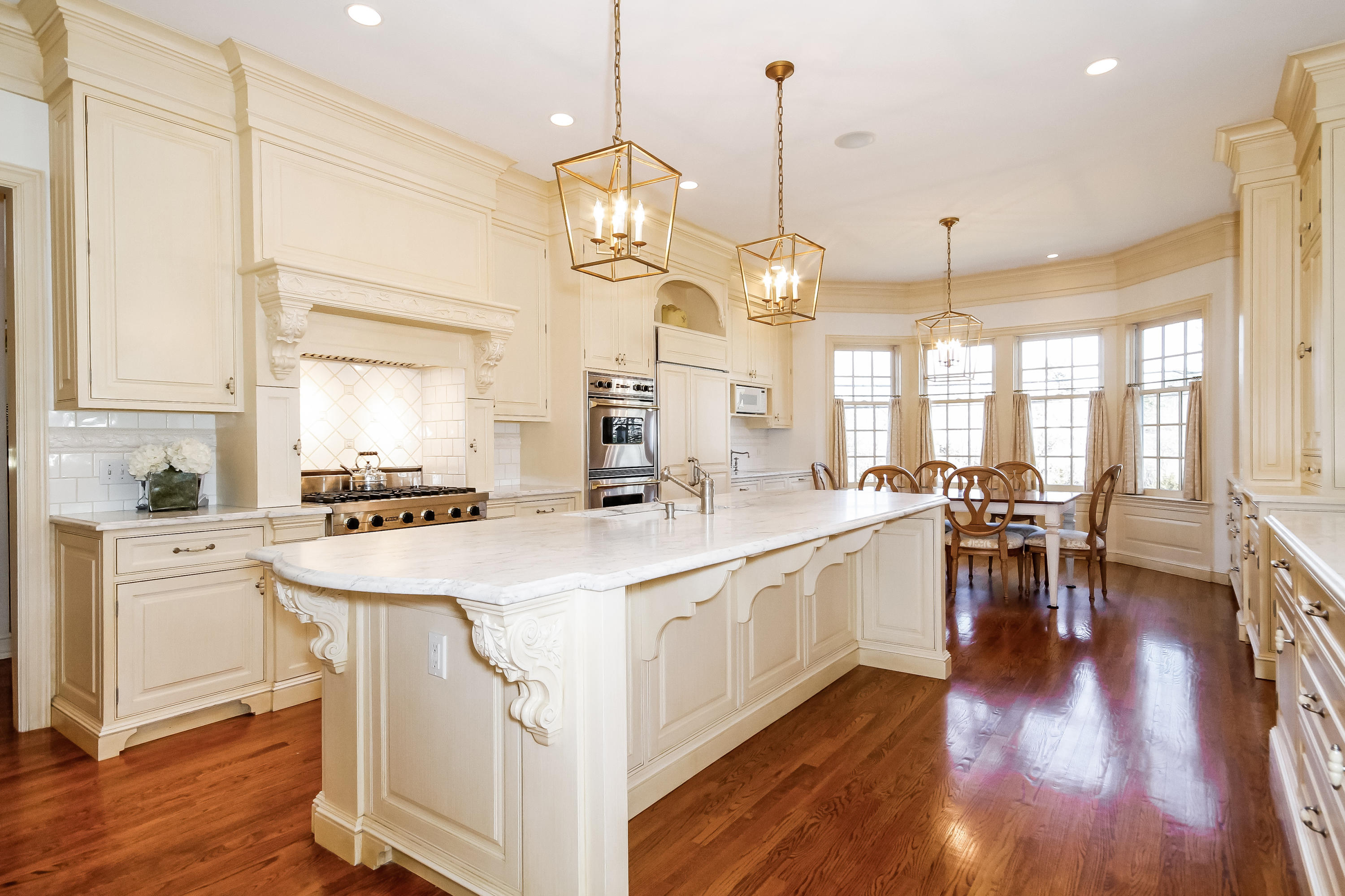 17 Searles Road Darien, CT 06820 - Photo 12 of 36 a large kitchen with lots of counter space a sink appliances and dining table