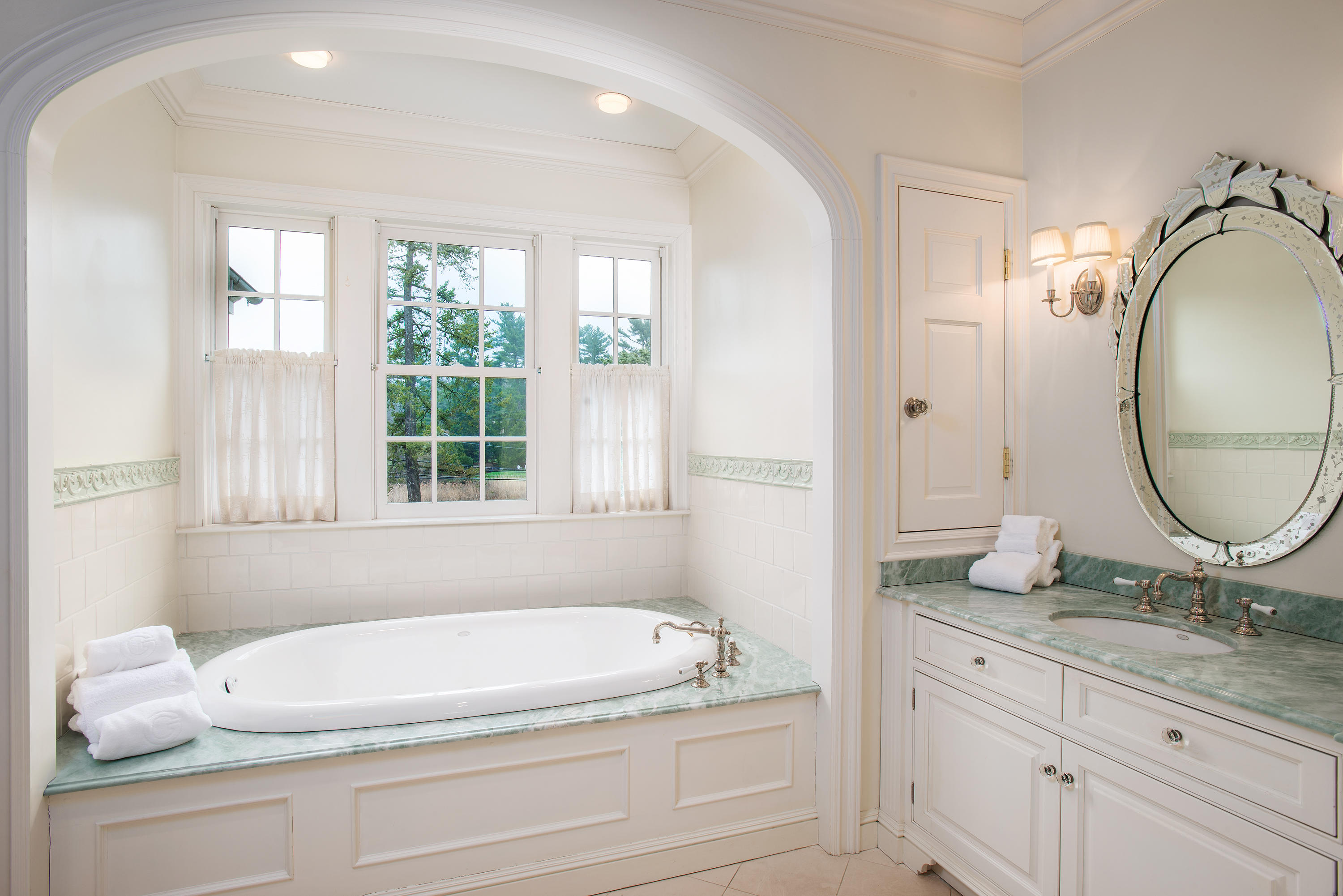 17 Searles Road Darien, CT 06820 - Photo 18 of 36 a bathroom with a granite countertop tub sink and mirror