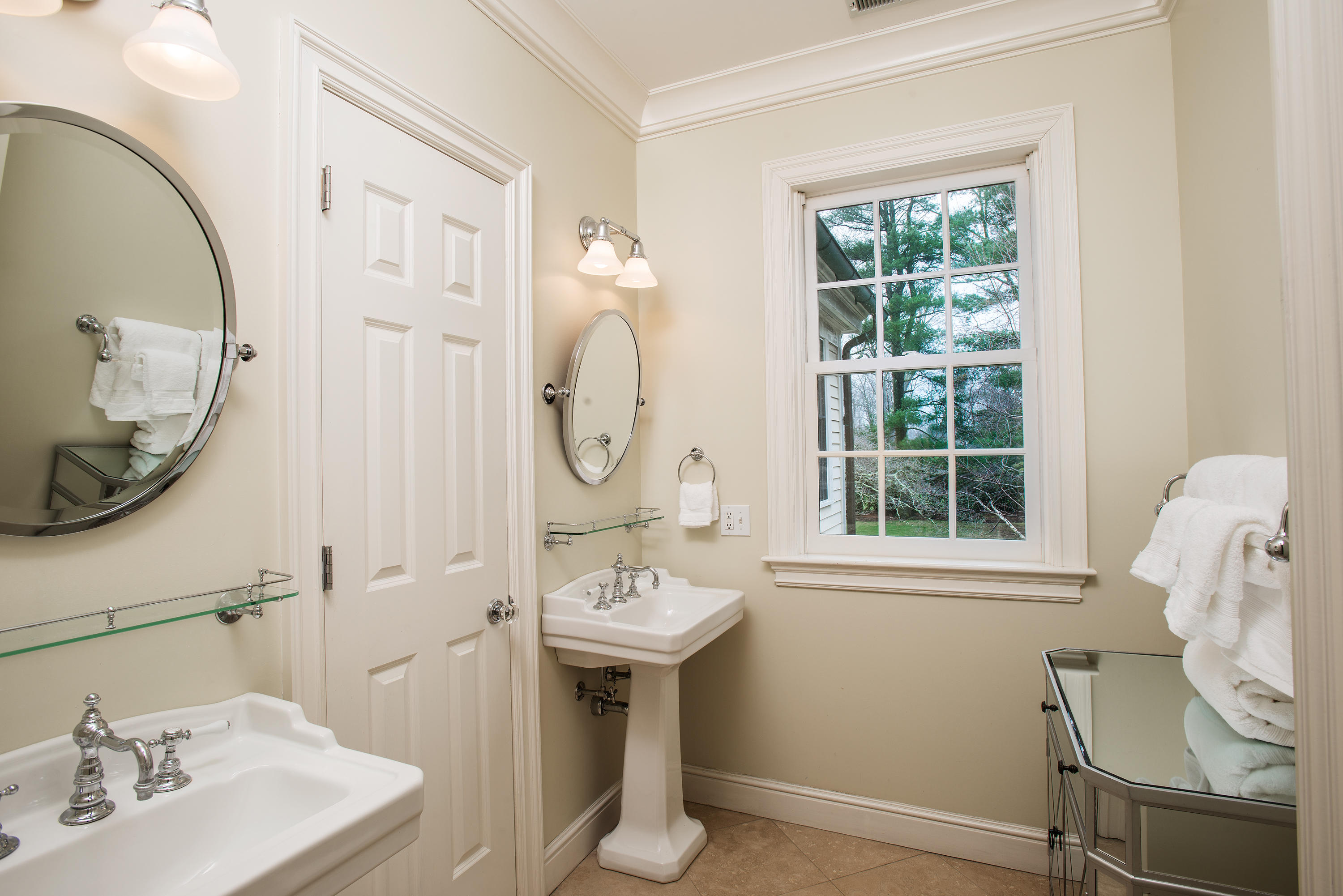 17 Searles Road Darien, CT 06820 - Photo 21 of 36 a bathroom with a sink a mirror and a window