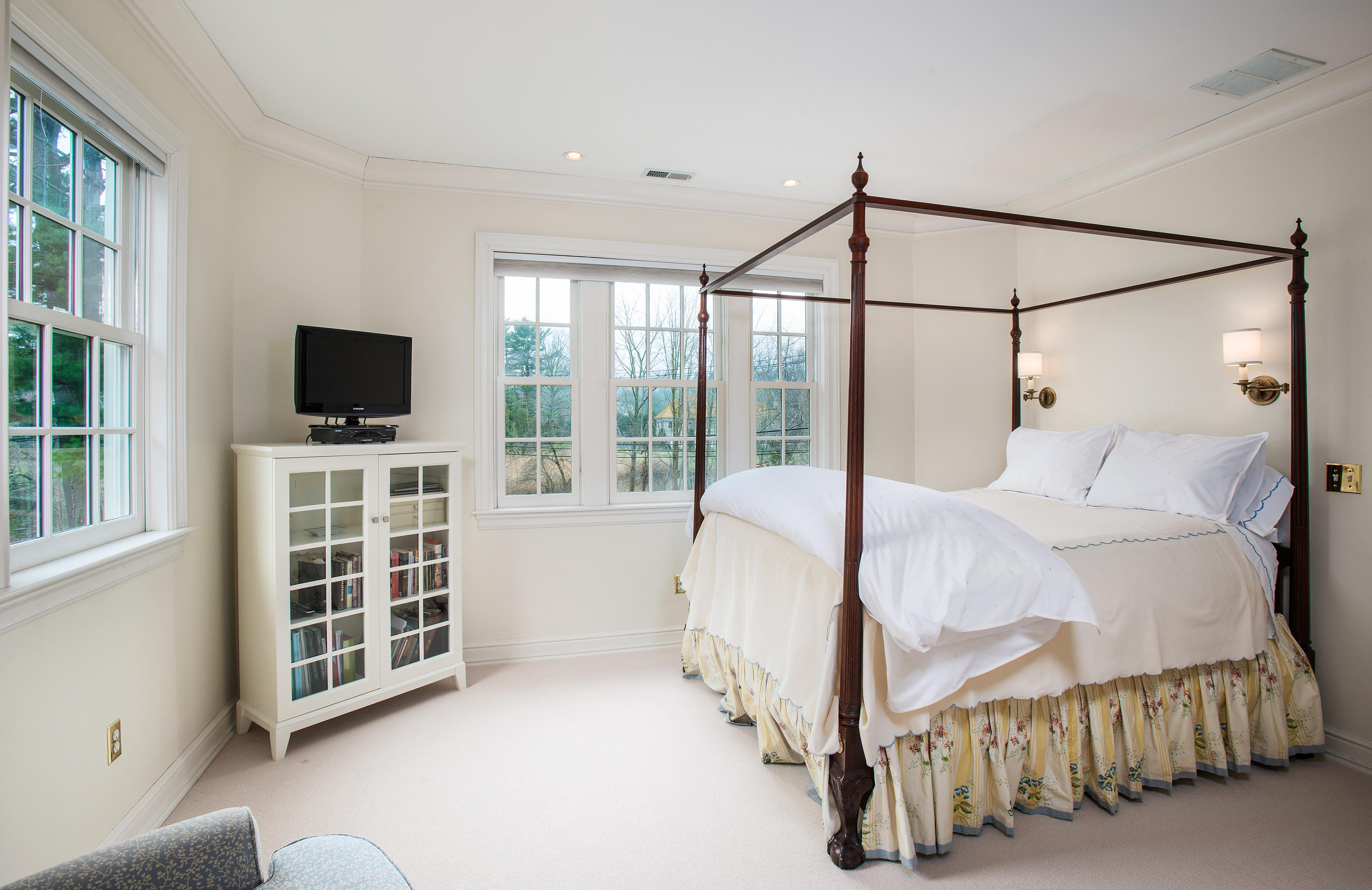 17 Searles Road Darien, CT 06820 - Photo 22 of 36 a bedroom with a bed and a flat tv screen next to a window