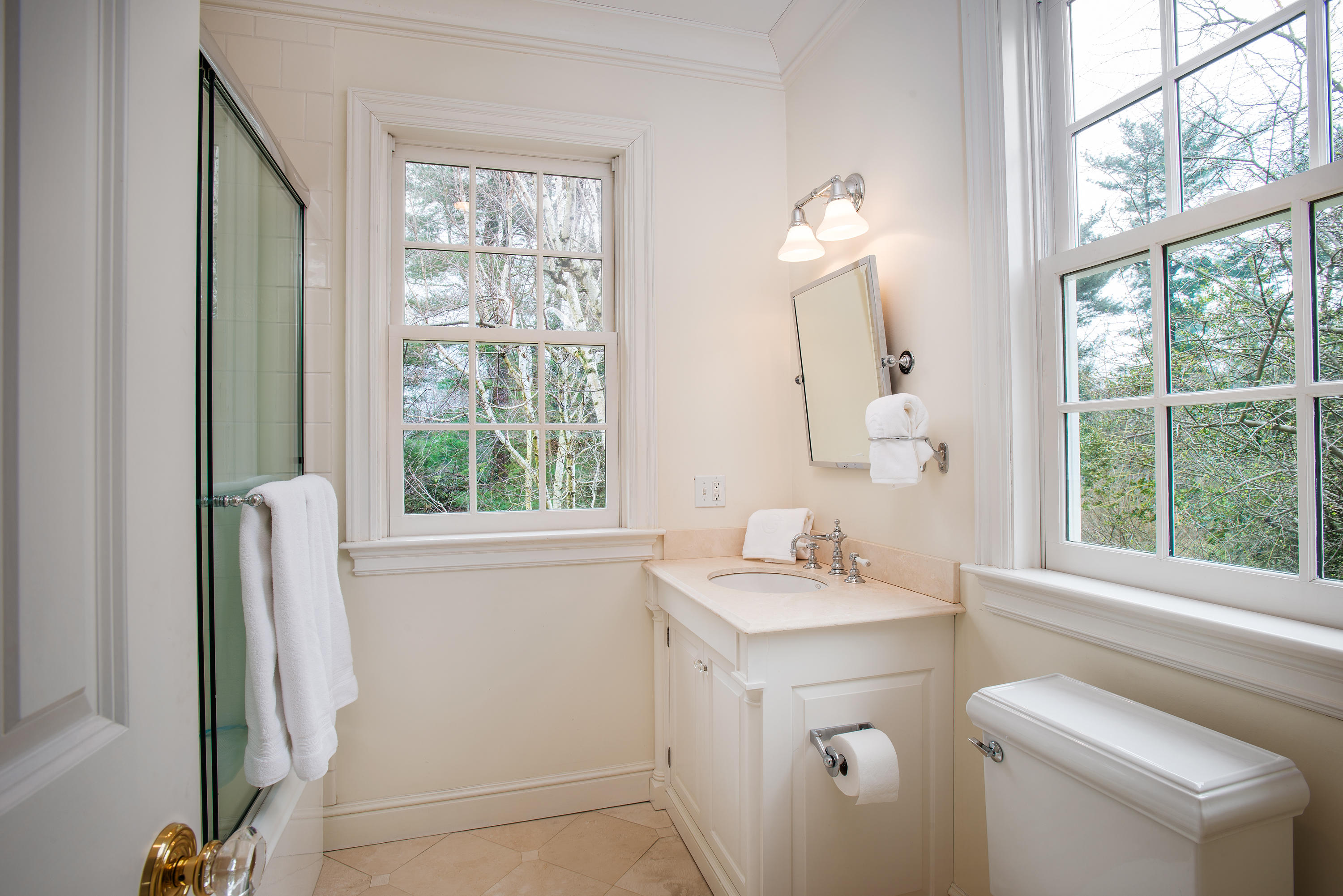 17 Searles Road Darien, CT 06820 - Photo 23 of 36 a bathroom with a sink and a mirror