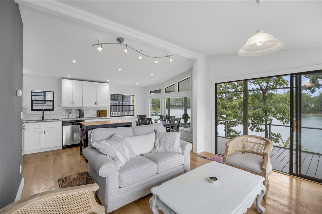 1230 Melton Road, Unit 30 West Union, SC 29696 - Photo 5 of 42 Panoramic lake views from this open-concept living space with sleek kitchen and natural light.
