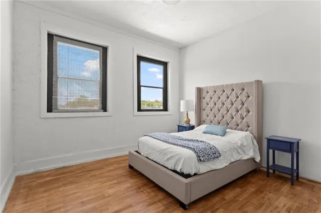 a bedroom with a bed lamp and window