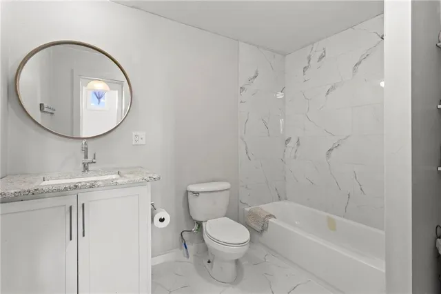 a bathroom with a toilet a sink and a mirror