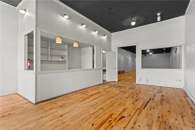 a view of empty room with wooden floor