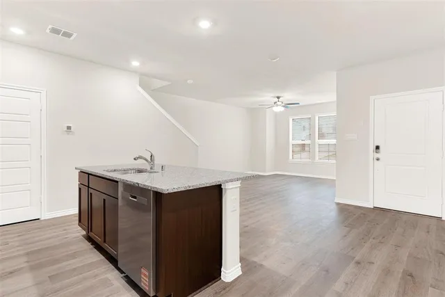 a view of a kitchen with a sink and wooden floor