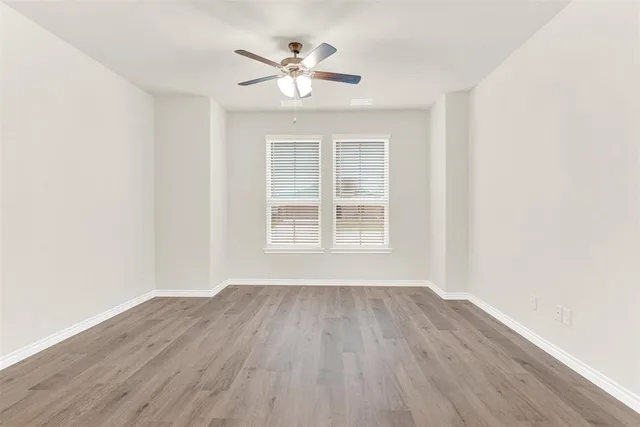 a view of kitchen with wooden floor and electronic appliances