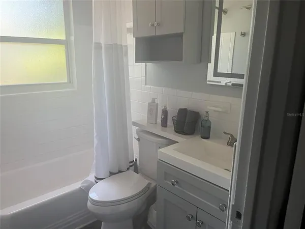 a white toilet sitting next to a bathroom sink