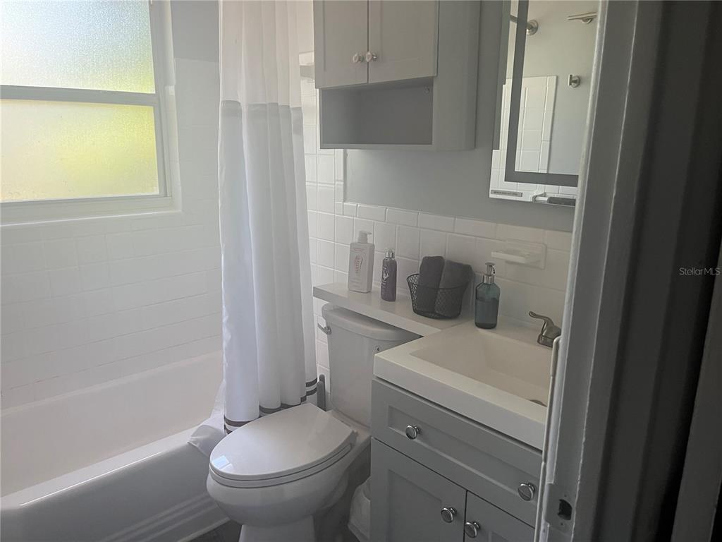 115 Cleveland Avenue Southwest Largo, FL 33770 - Photo 11 of 15 a white toilet sitting next to a bathroom sink