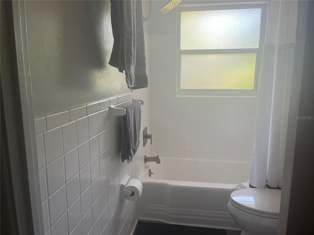 115 Cleveland Avenue Southwest Largo, FL 33770 - Photo 9 of 15 a bathroom with a bathtub and a shower