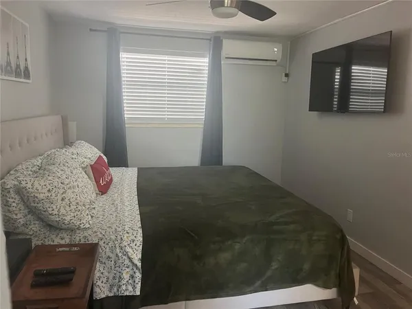 a bedroom with a bed and a fireplace