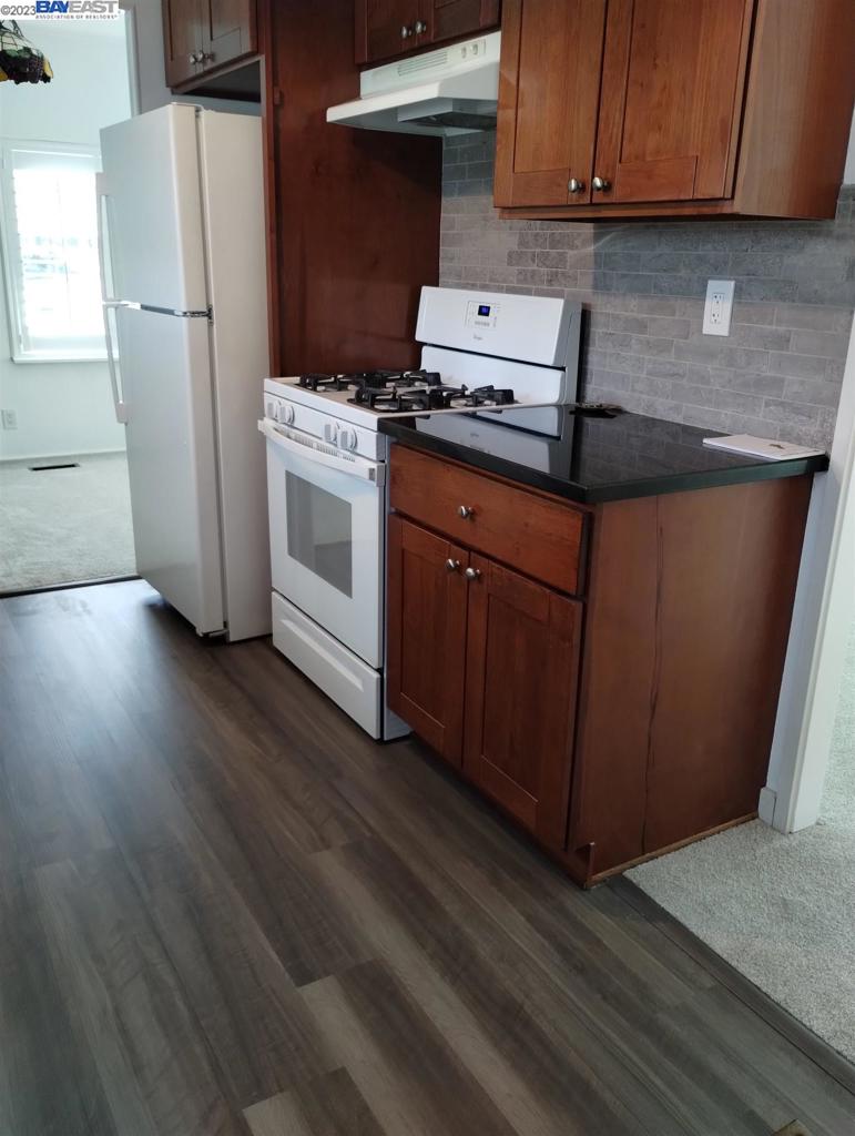2073 Dalis Drive Concord, CA 94520 - Photo 9 of 15 a kitchen with a stove top oven and refrigerator