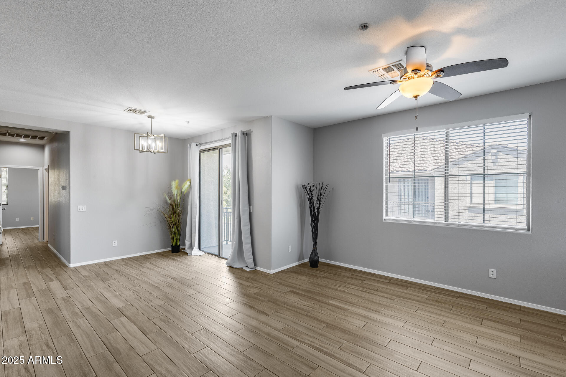 2941 East Darrow Street Phoenix, AZ 85042 - Photo 15 of 48 a view of an empty room with wooden floor and a window
