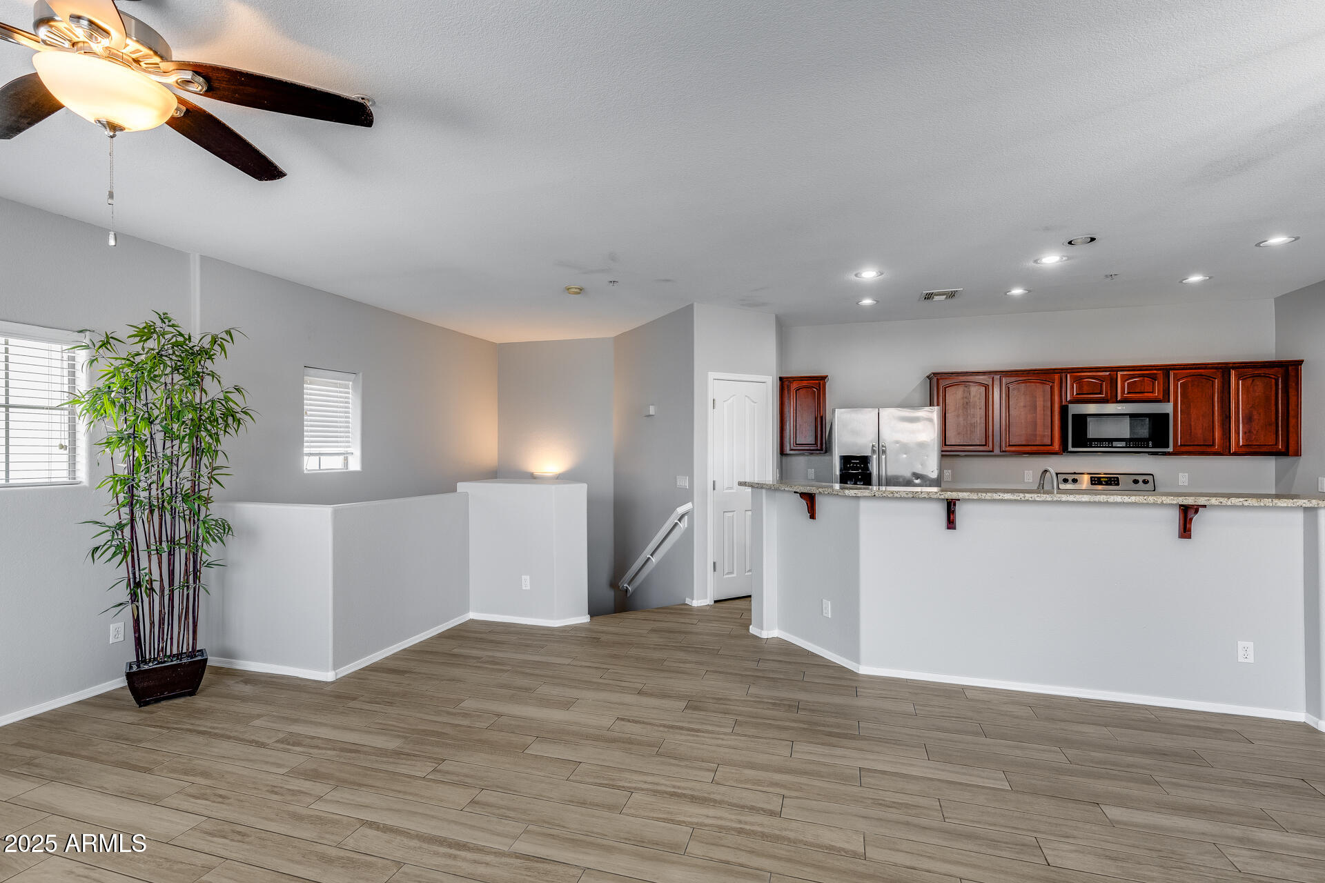2941 East Darrow Street Phoenix, AZ 85042 - Photo 17 of 48 a view of kitchen with microwave a refrigerator and a white cabinets