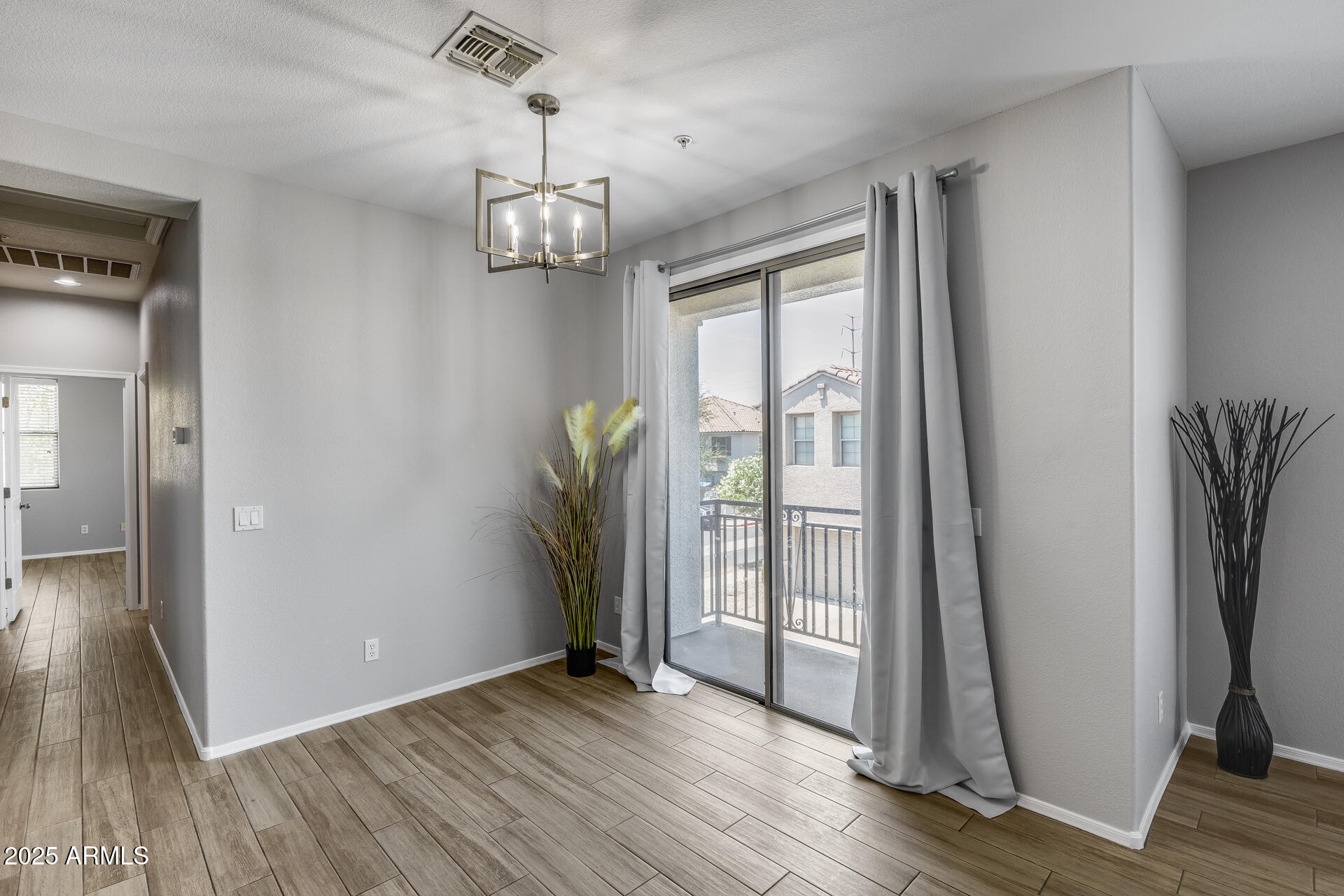 2941 East Darrow Street Phoenix, AZ 85042 - Photo 26 of 48 a view of empty room with wooden floor and fan