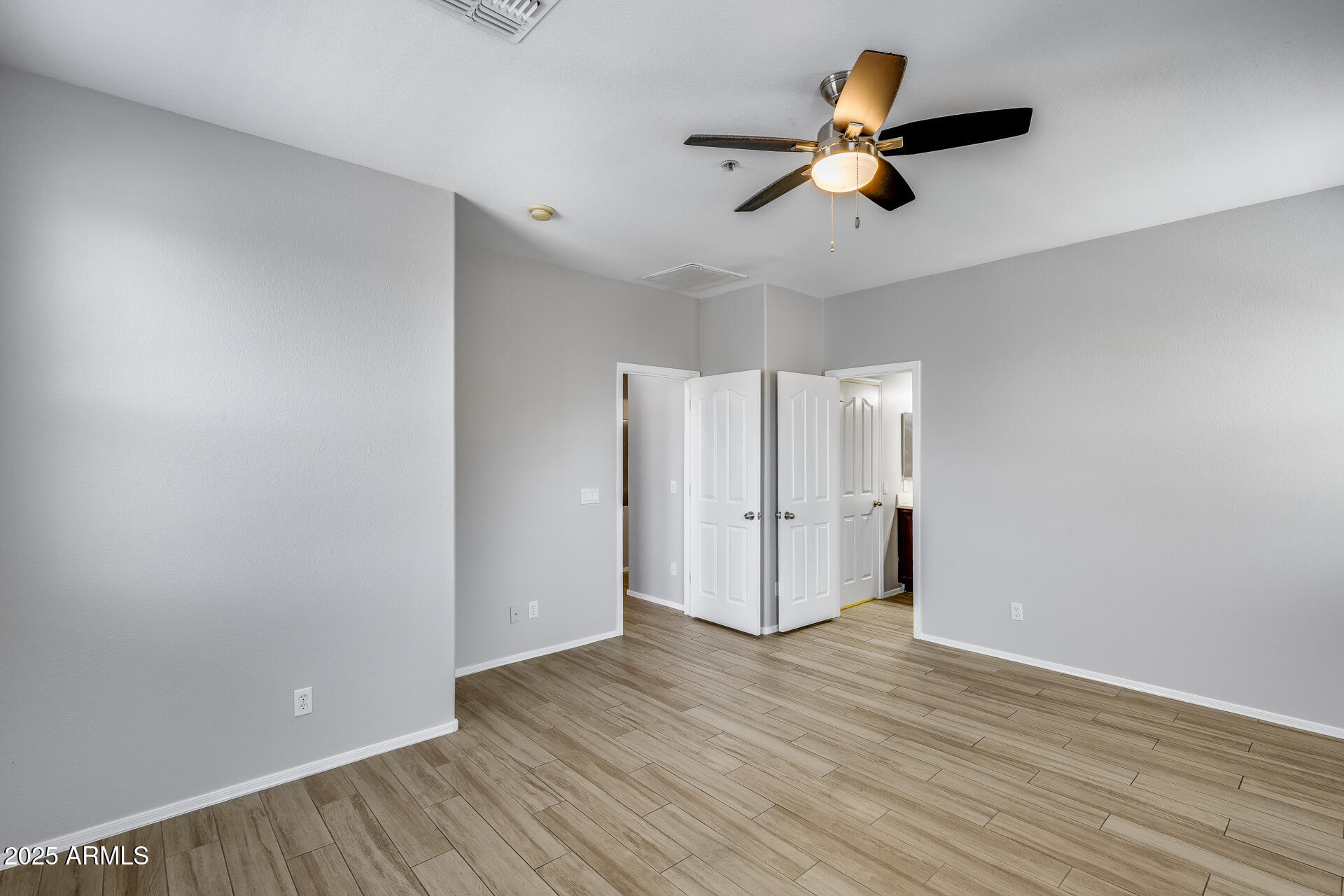 2941 East Darrow Street Phoenix, AZ 85042 - Photo 35 of 48 an empty room with wooden floor ceiling fan and windows