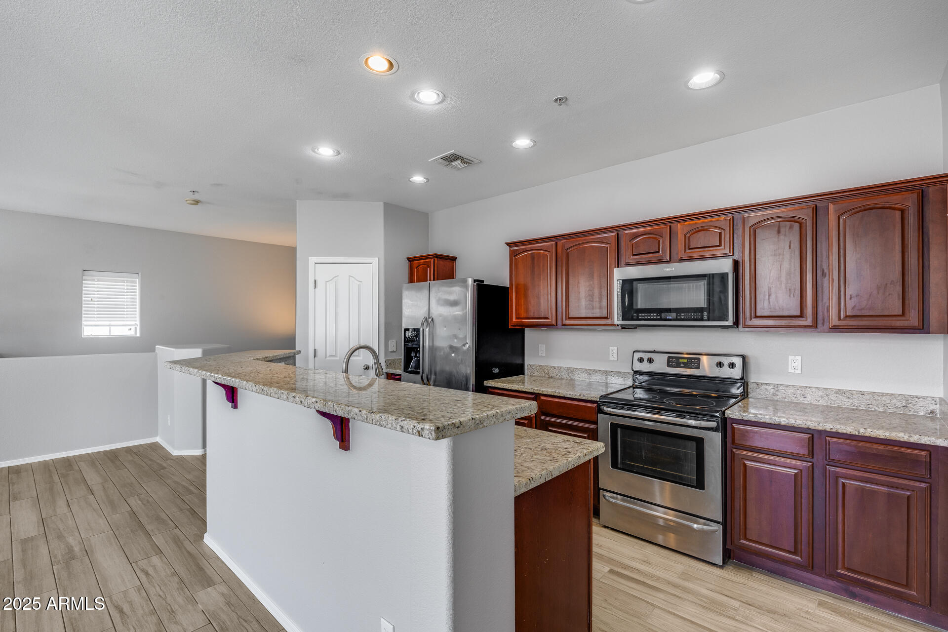 2941 East Darrow Street Phoenix, AZ 85042 - Photo 3 of 48 a kitchen with stainless steel appliances granite countertop a sink stove and refrigerator