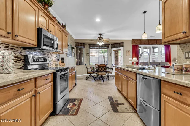a kitchen with stainless steel appliances granite countertop a sink and cabinets
