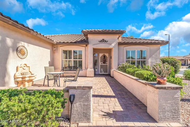 a view of a house with potted plants