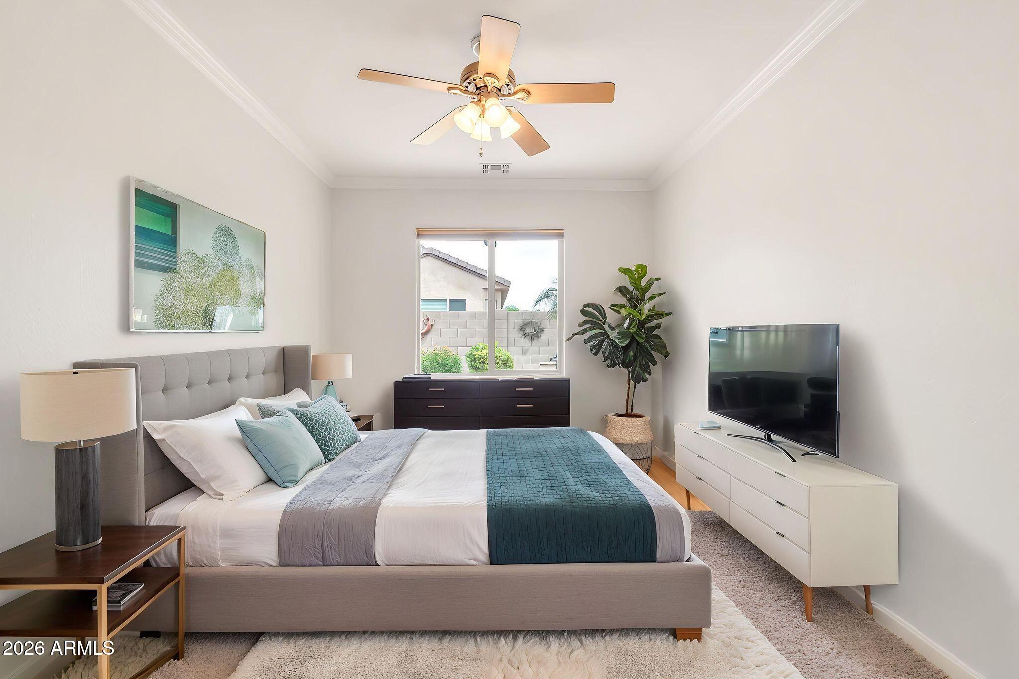6959 South Rincon Drive Chandler, AZ 85249 - Photo 11 of 25 a bedroom with a large bed and a flat screen tv