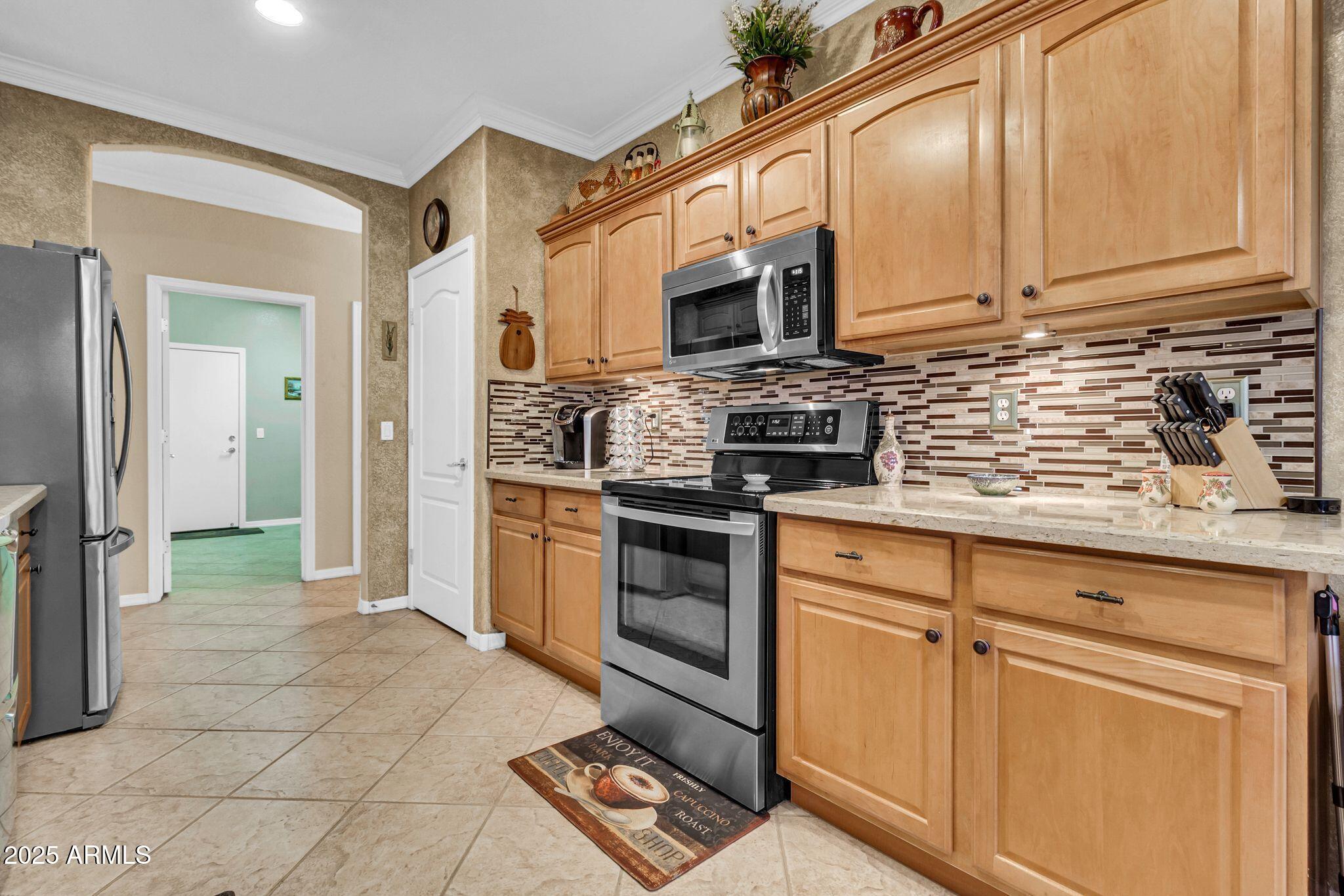 6959 South Rincon Drive Chandler, AZ 85249 - Photo 15 of 38 a kitchen with stainless steel appliances granite countertop a stove and a sink