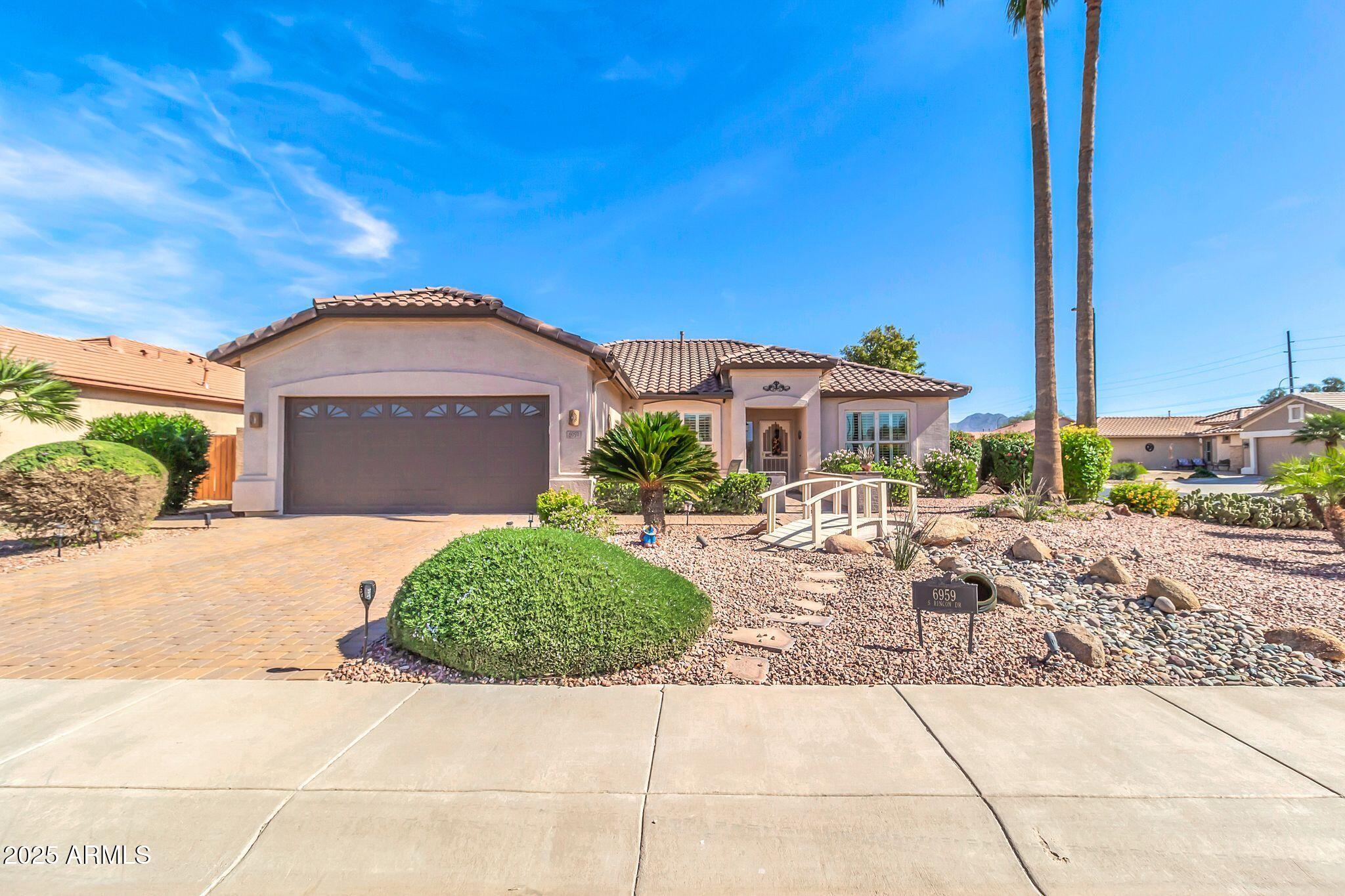 6959 South Rincon Drive Chandler, AZ 85249 - Photo 16 of 25 a front view of a house with a garden