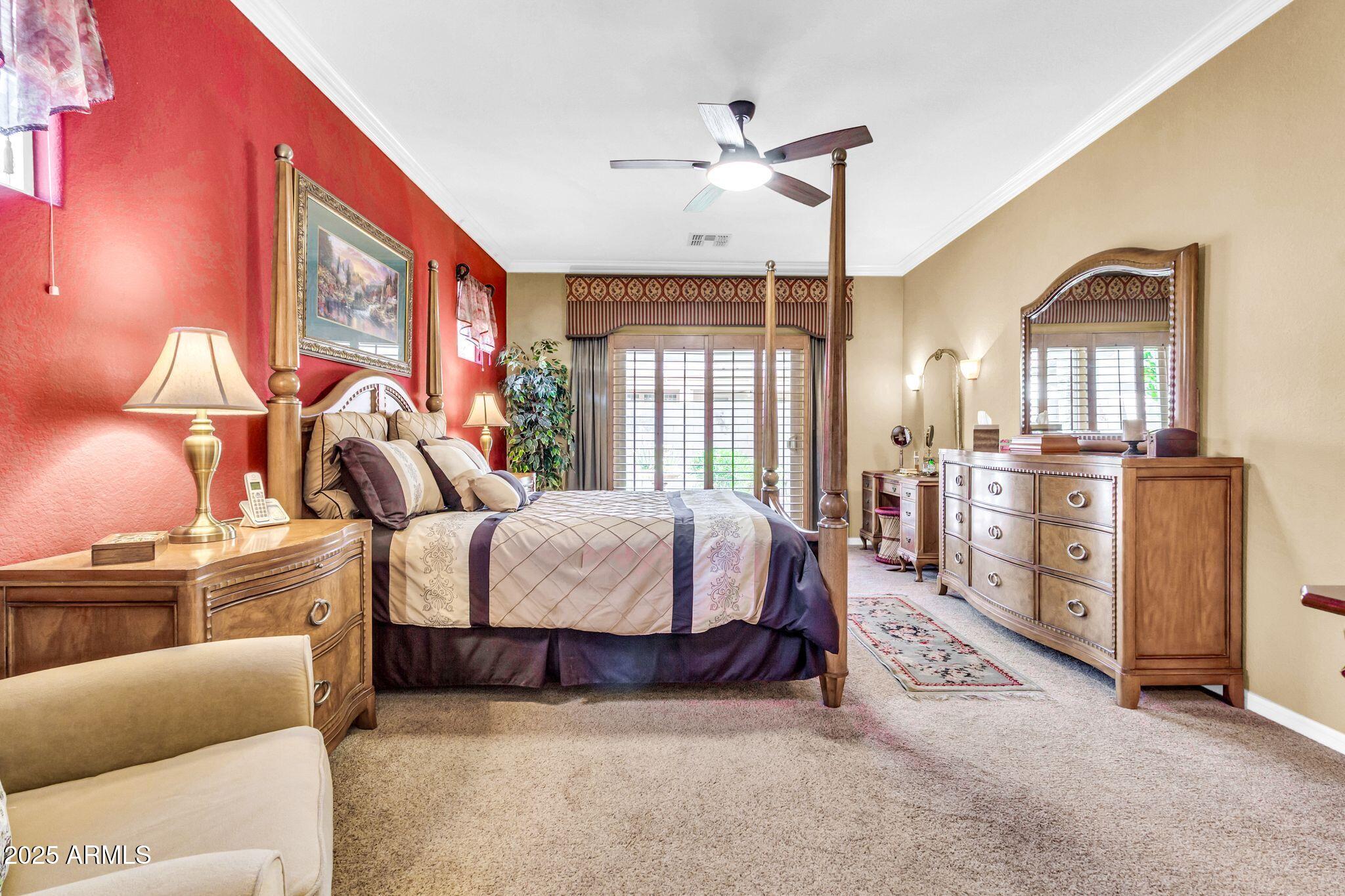 6959 South Rincon Drive Chandler, AZ 85249 - Photo 18 of 38 a spacious bedroom with a bed a chandelier and dresser