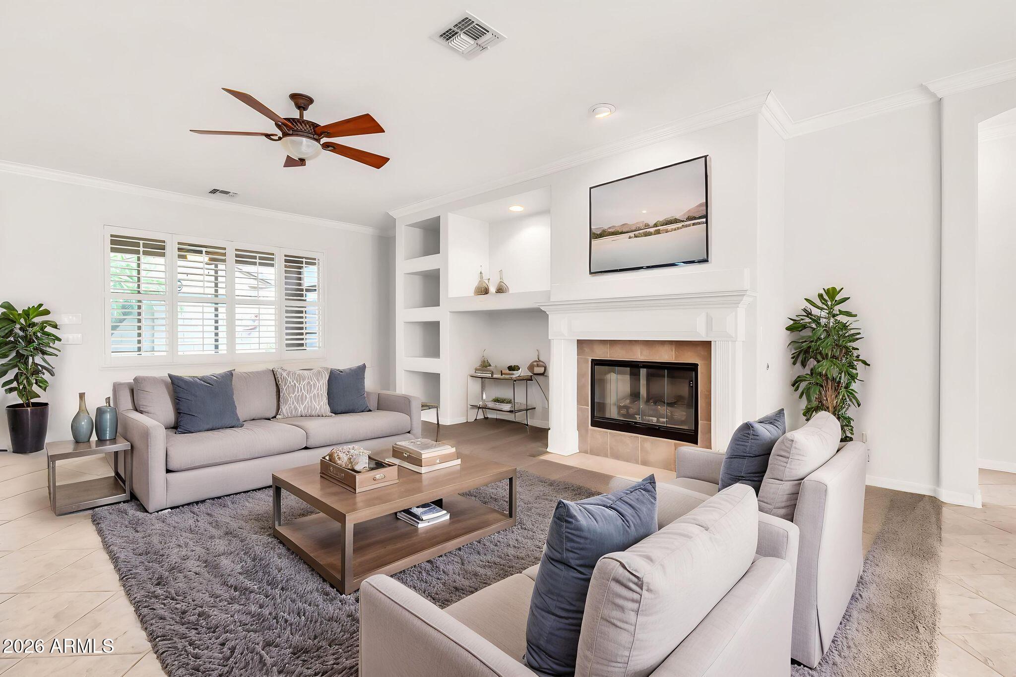 6959 South Rincon Drive Chandler, AZ 85249 - Photo 2 of 25 a living room with furniture and a fireplace