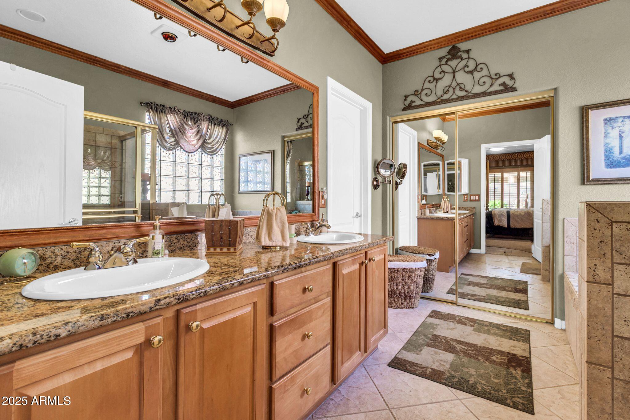 6959 South Rincon Drive Chandler, AZ 85249 - Photo 21 of 38 a spacious bathroom with a granite countertop sink and a mirror
