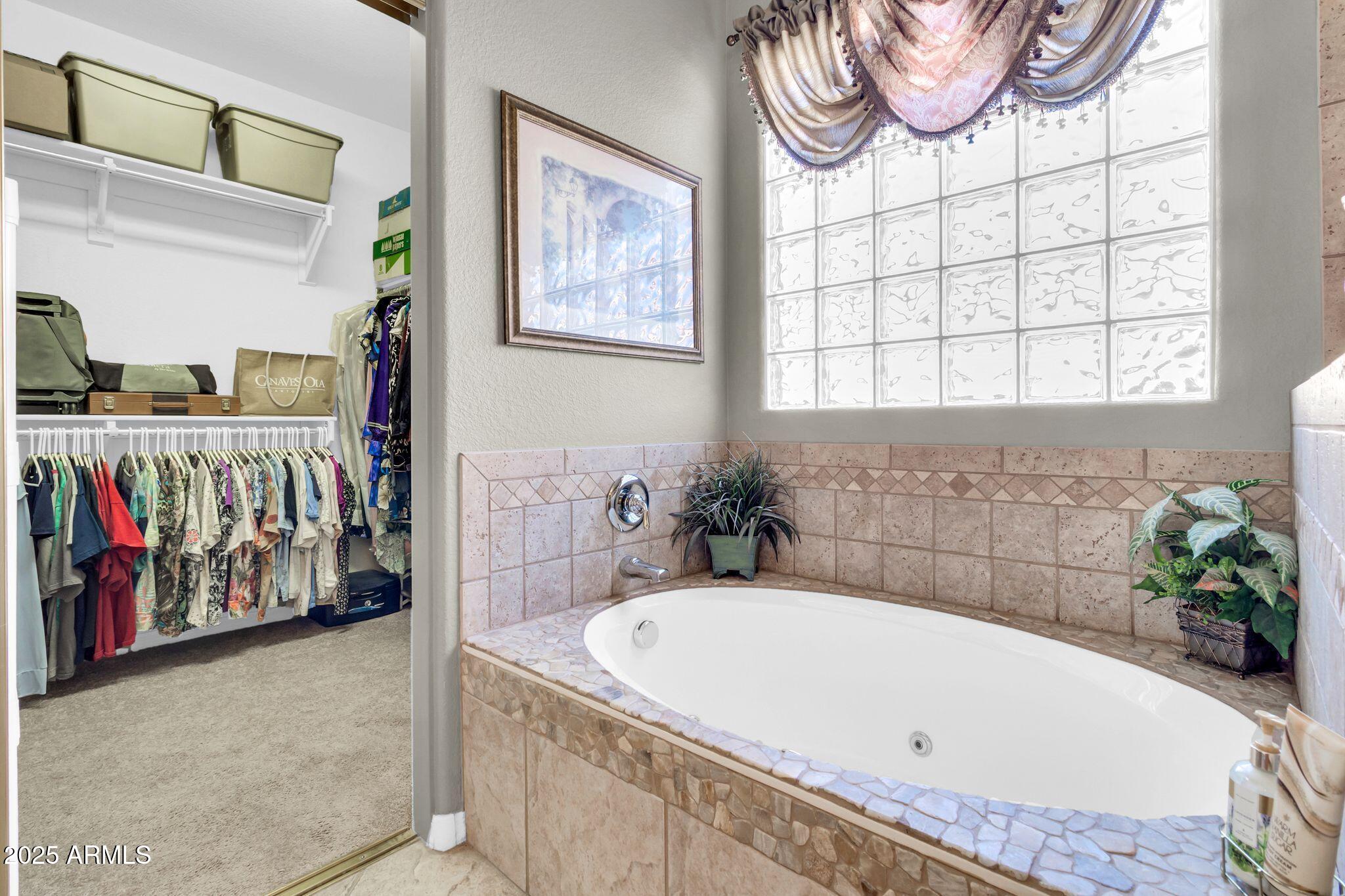 6959 South Rincon Drive Chandler, AZ 85249 - Photo 22 of 38 a bathroom with a tub and a shower