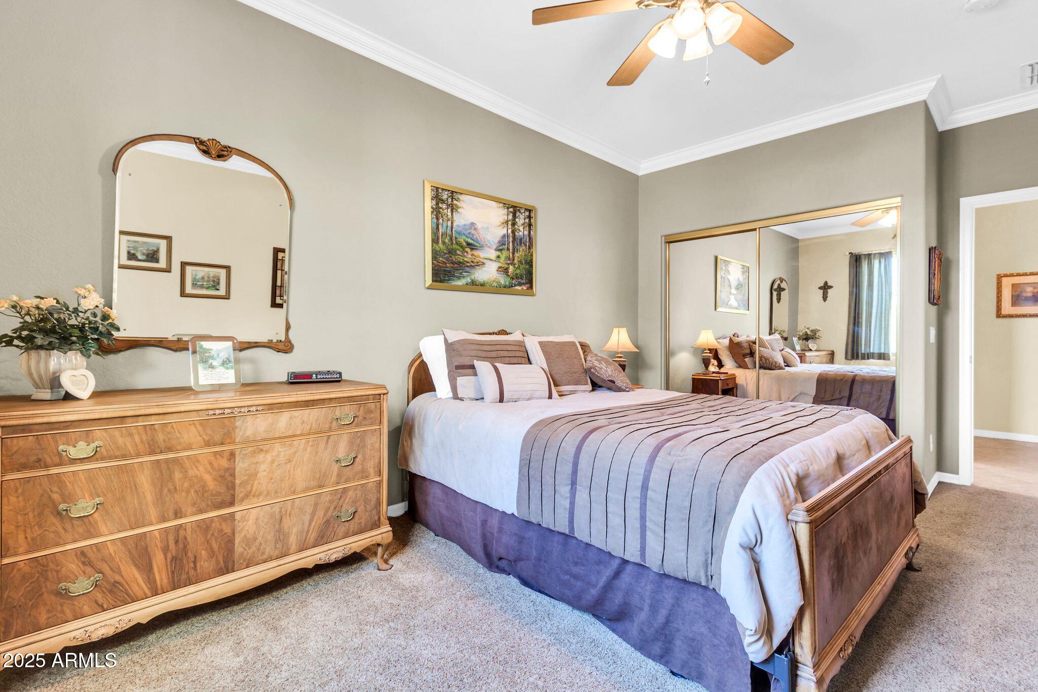 6959 South Rincon Drive Chandler, AZ 85249 - Photo 24 of 38 a spacious bedroom with a bed and a chandelier