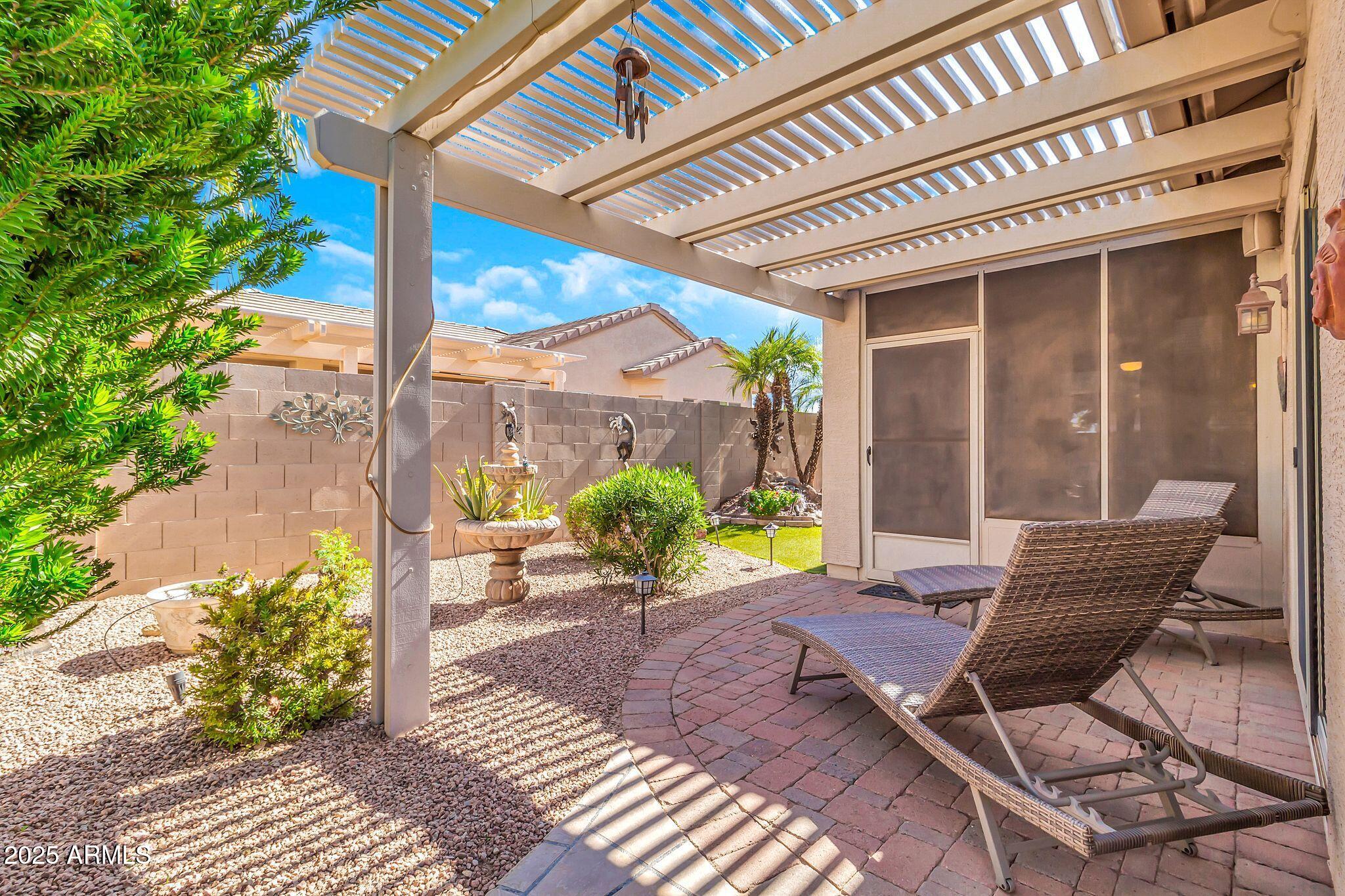 6959 South Rincon Drive Chandler, AZ 85249 - Photo 27 of 38 a view of a patio with table and chairs potted plants with wooden floor and fence
