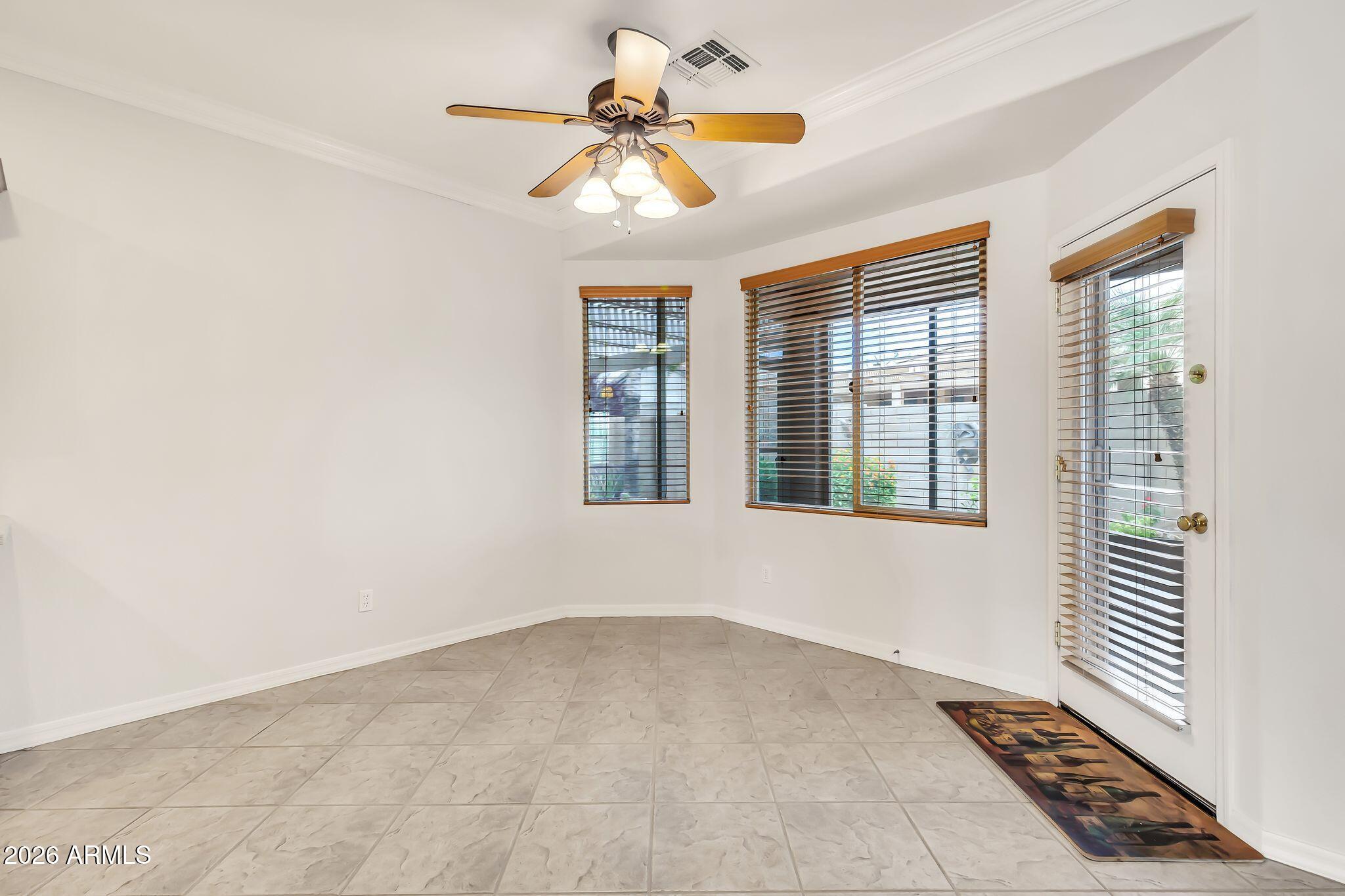 6959 South Rincon Drive Chandler, AZ 85249 - Photo 6 of 25 an empty room with windows and fan