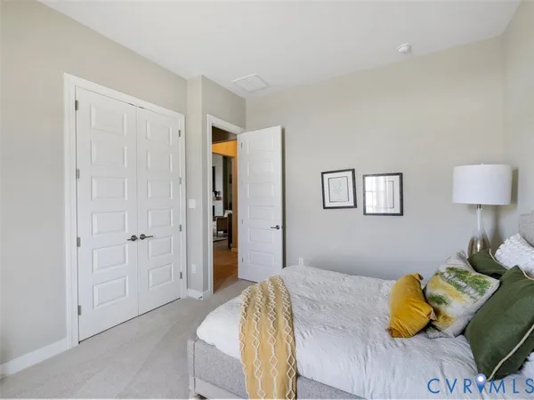 a bedroom with a bed and cupboard